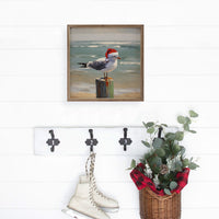 Seagull wearing a Santa hat on a beach with ocean in the background wood sign - Island Soul Clothing & Gifts Seaside Heights New Jersey