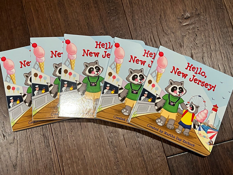 Children's book titled 'Hello, New Jersey!' with illustrations of raccoons on the boardwalk - Island Soul Clothing & Gifts Seaside Heights New Jersey