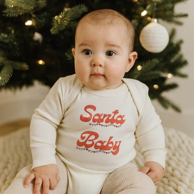 Long sleeve baby onesie with red  "Santa Baby" text in red with Christmas Lights Graphic on a white background - Island Soul Clothing & Gifts Seaside Heights New Jersey