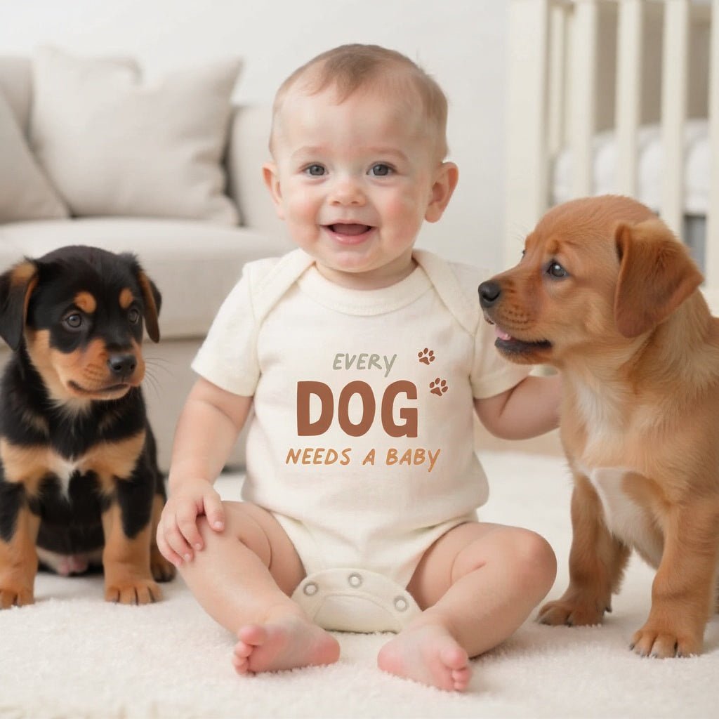 Baby onesie with 'Every Dog Needs a Baby' text on a white background - Island Soul Clothing & Gifts Seaside Heights New Jersey