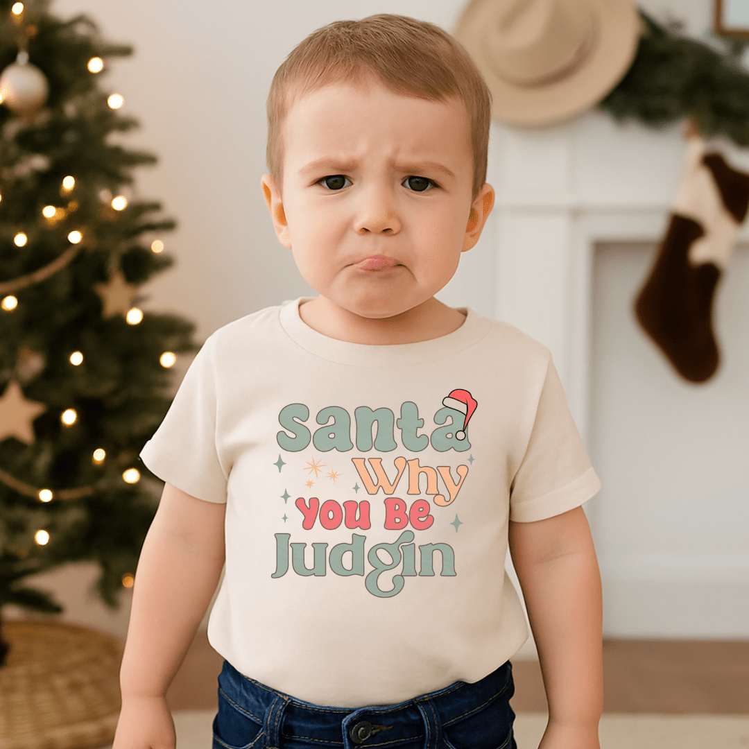 Beige toddler t-shirt with colorful text 'Santa Why You Be Judgin' on a white background - Island Soul Clothing & Gifts Seaside Heights New Jersey