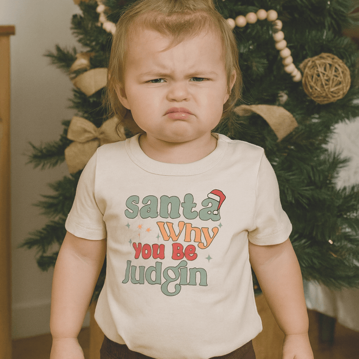 Beige toddler t-shirt with colorful text 'Santa Why You Be Judgin' on a white background - Island Soul Clothing & Gifts Seaside Heights New Jersey
